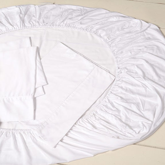 Bamboo cot sheet set — white sheets staged on a cot