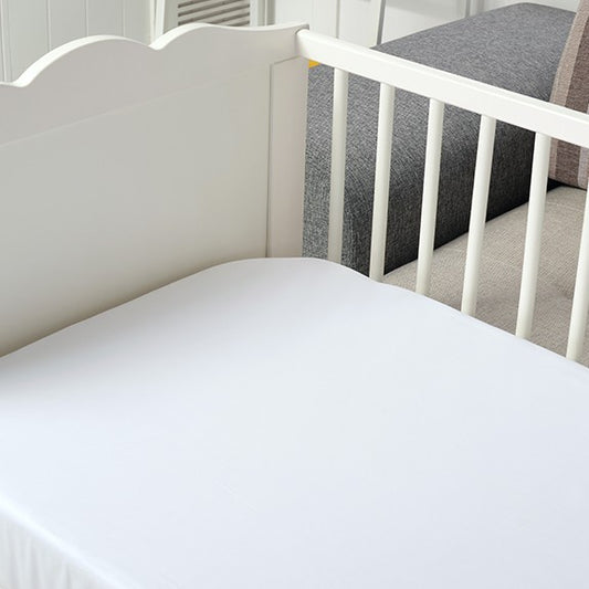 Bamboo cot sheet set — white fitted sheet on a timber cot
