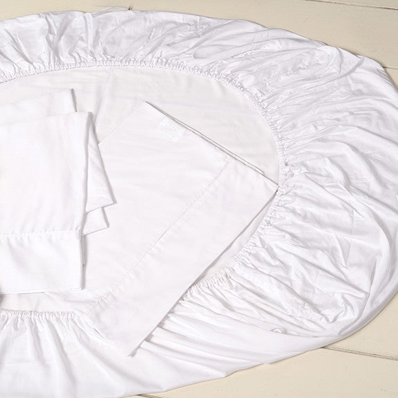Bamboo cot sheet set — white sheets staged on a cot