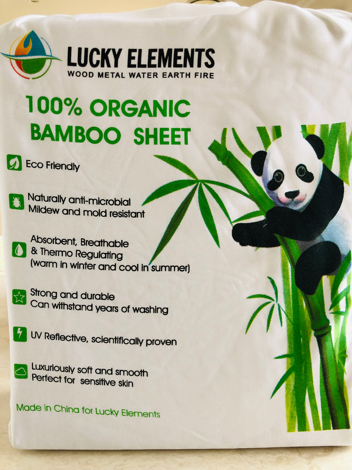 Bamboo cot sheet set in Lucky Elements packaging bag