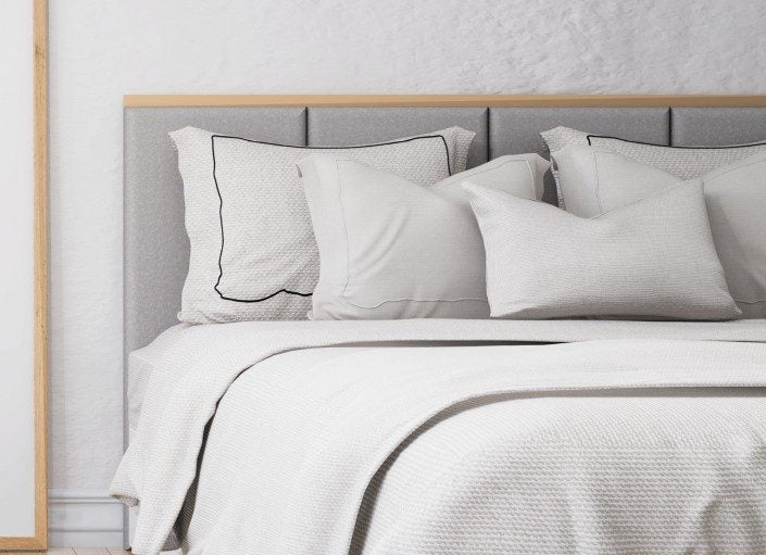Bamboo bed sheet sets in white and grey with pillowcases on a bed