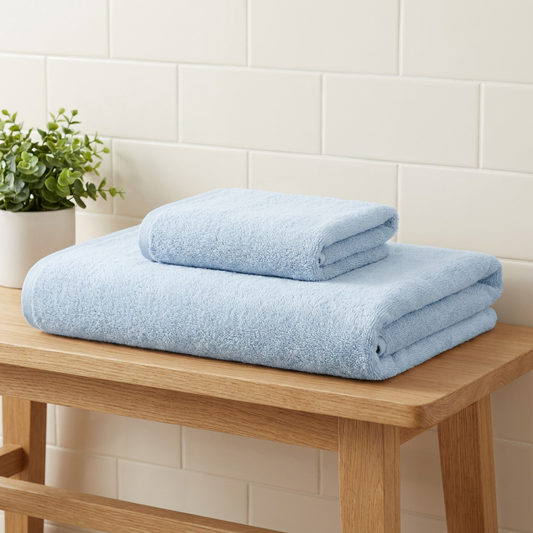 Blue bamboo bath towel set with matching hand towels — folded stack