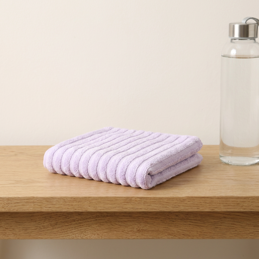 Bamboo hand towel / gym towel in Purple — small folded towel with water bottle for scale